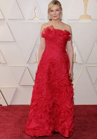 Kirsten Dunst wearing a red gown at the oscars