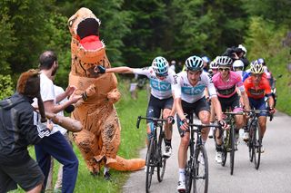 Chris Froome (Team Sky) tries to signal to the running T-Rex to move out of the way, stage 14