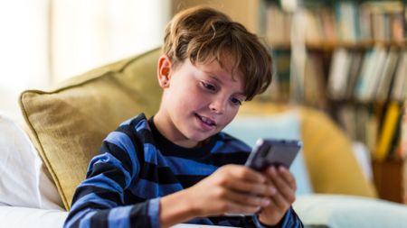 A boy looking at a smartphone