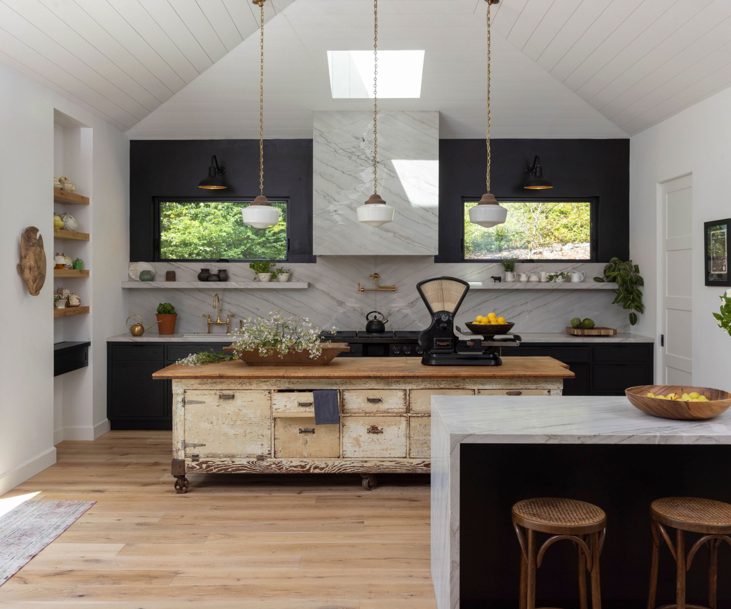 Kitchen with white panelled ceilings, skylights, marble bar, and salvaged island