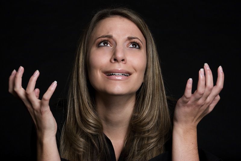 A woman pleading or praying to God.