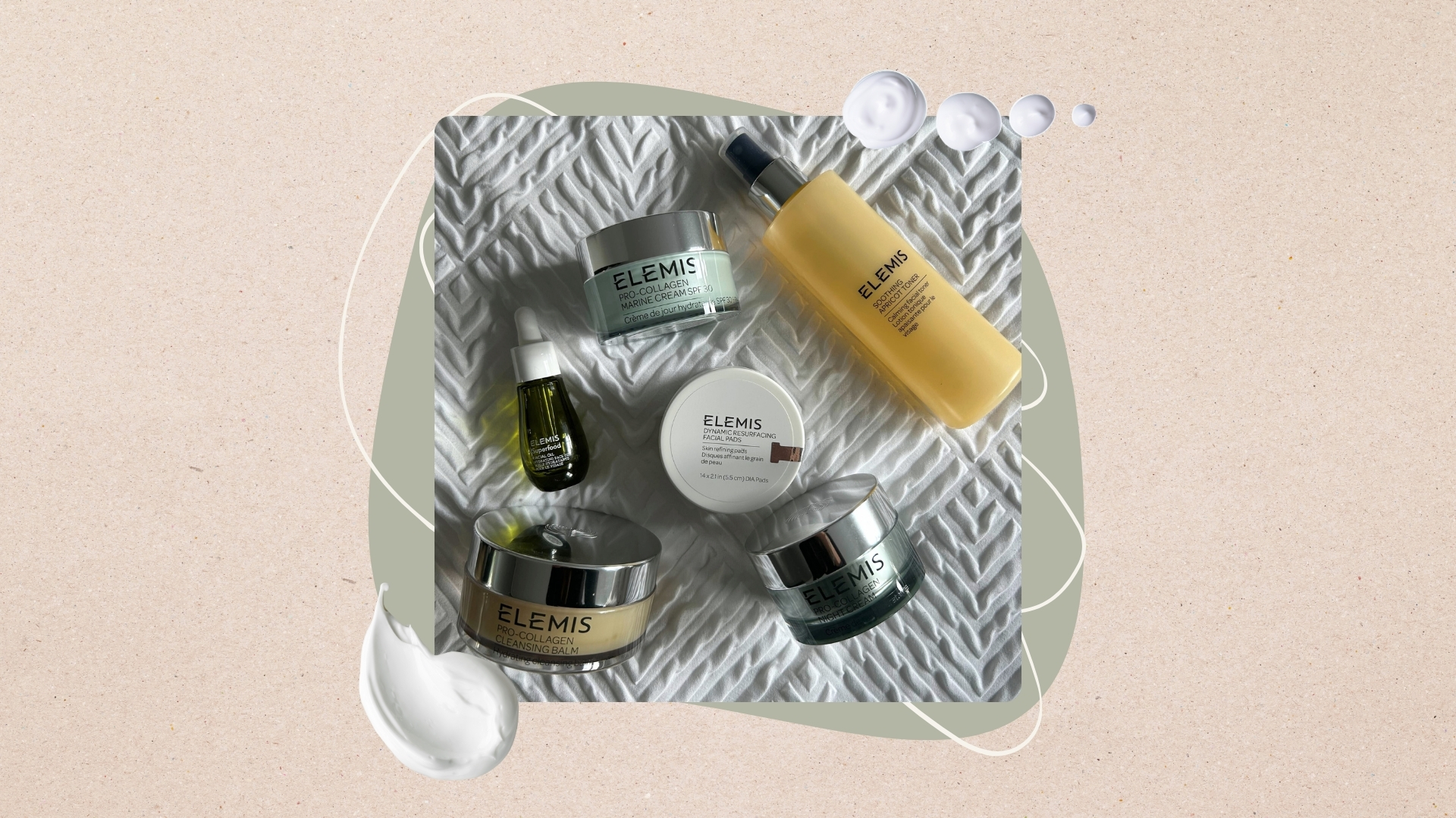 Image of the best Elemis products laid out on bed, on a beige background with sage green circle and cream swatches