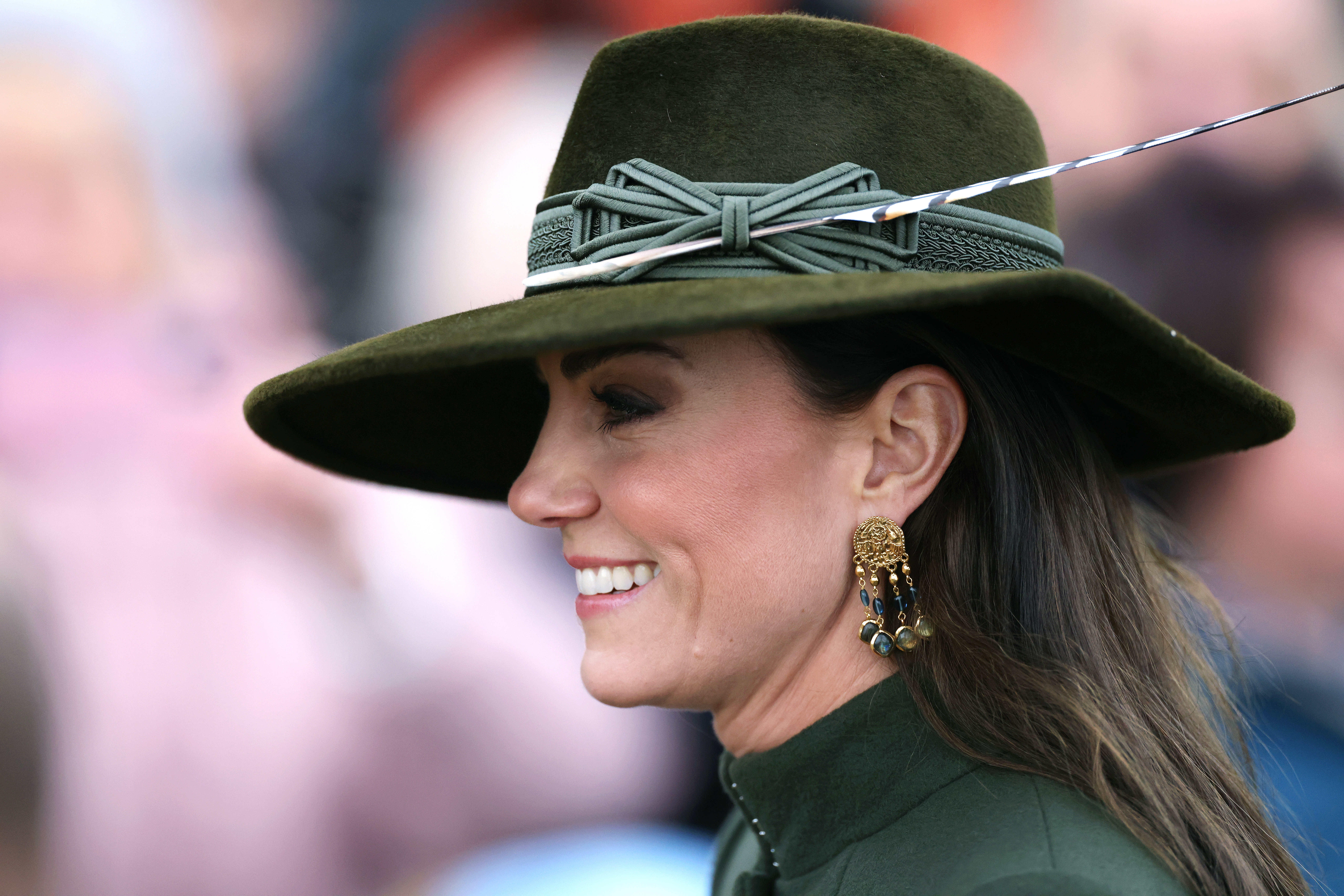 Princess Kate wearing a green hat and smiling