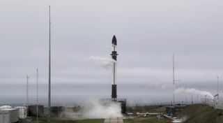 A Rocket Lab Electron booster stands poised to launch the "In Focus" mission from New Zealand on Oct. 21, 2020. The planned launch was scrubbed because Rocket Lab wanted to examine sensor data further.