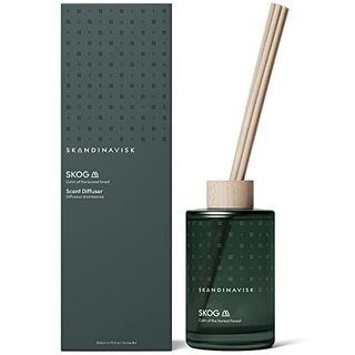 Skandinavisk Skog 'forest' Scent Diffuser With 8 Reeds. Both the box and the glass vessel are dark forest green with a square dot design on the top half, and matte finish on the bottom