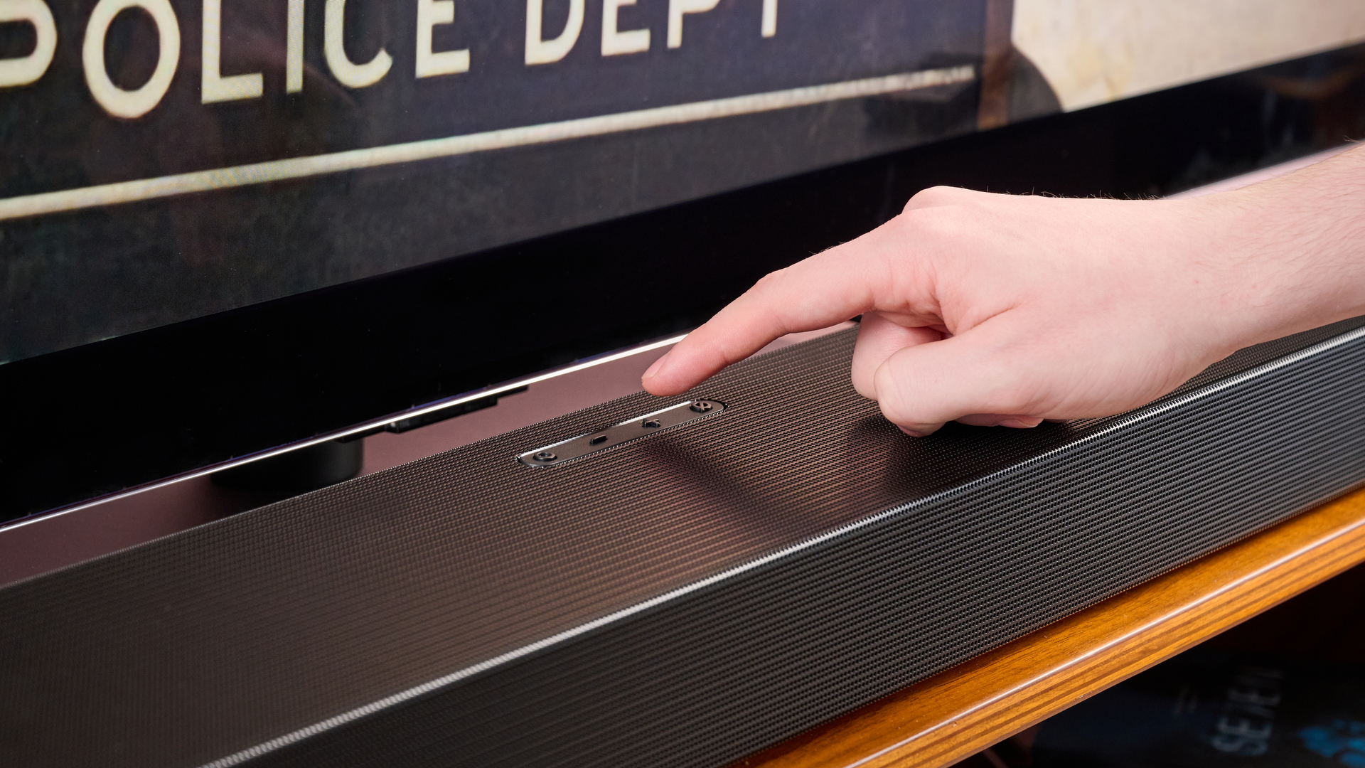 Person pressing button on the Samsung HW-Q800F