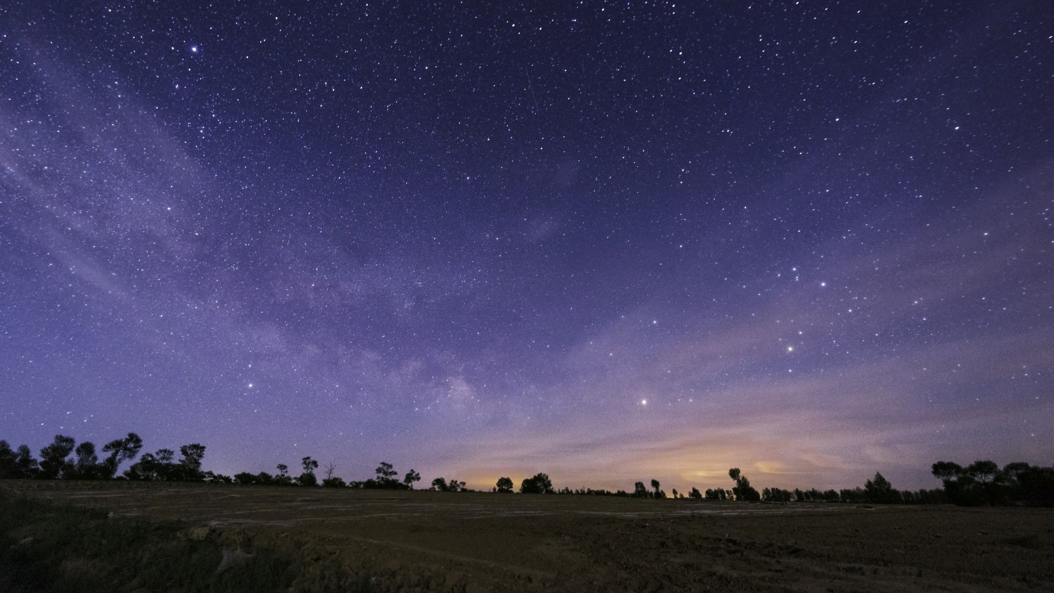 Why do stars appear different colors in the night sky?