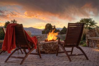 DIY fire pit ideas on a patio at sunset