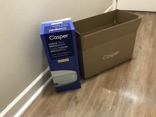 A Casper Hybrid Pillow with Snow Technology box, next to its outer box