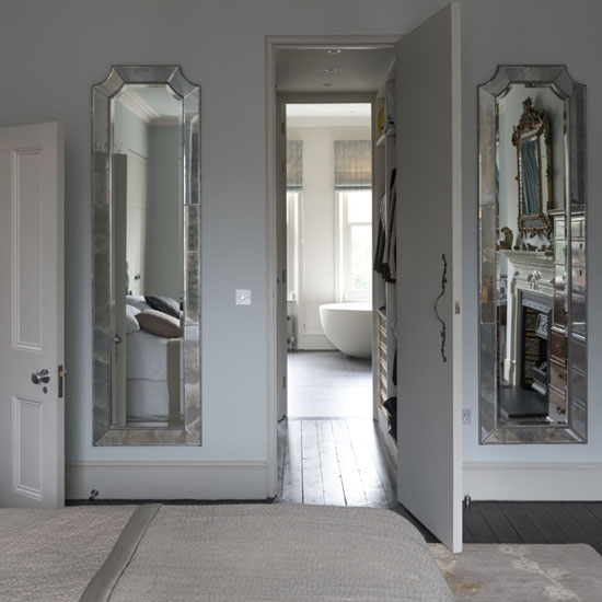 bedroom with twin mirror and wooden flooring