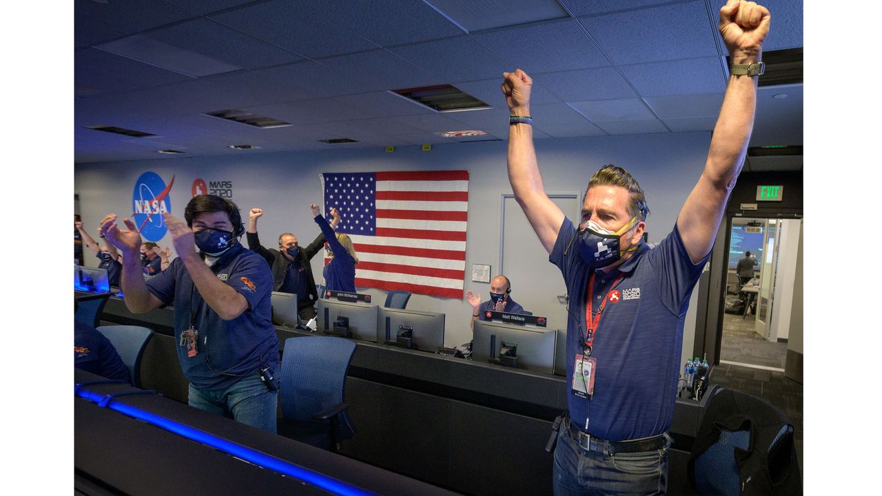 Members of NASA&rsquo;s Perseverance rover team react in mission control after receiving confirmation the spacecraft successfully touched down on Mars, Thursday, Feb. 18, 2021, at NASA's Jet Propulsion Laboratory in Pasadena, California.