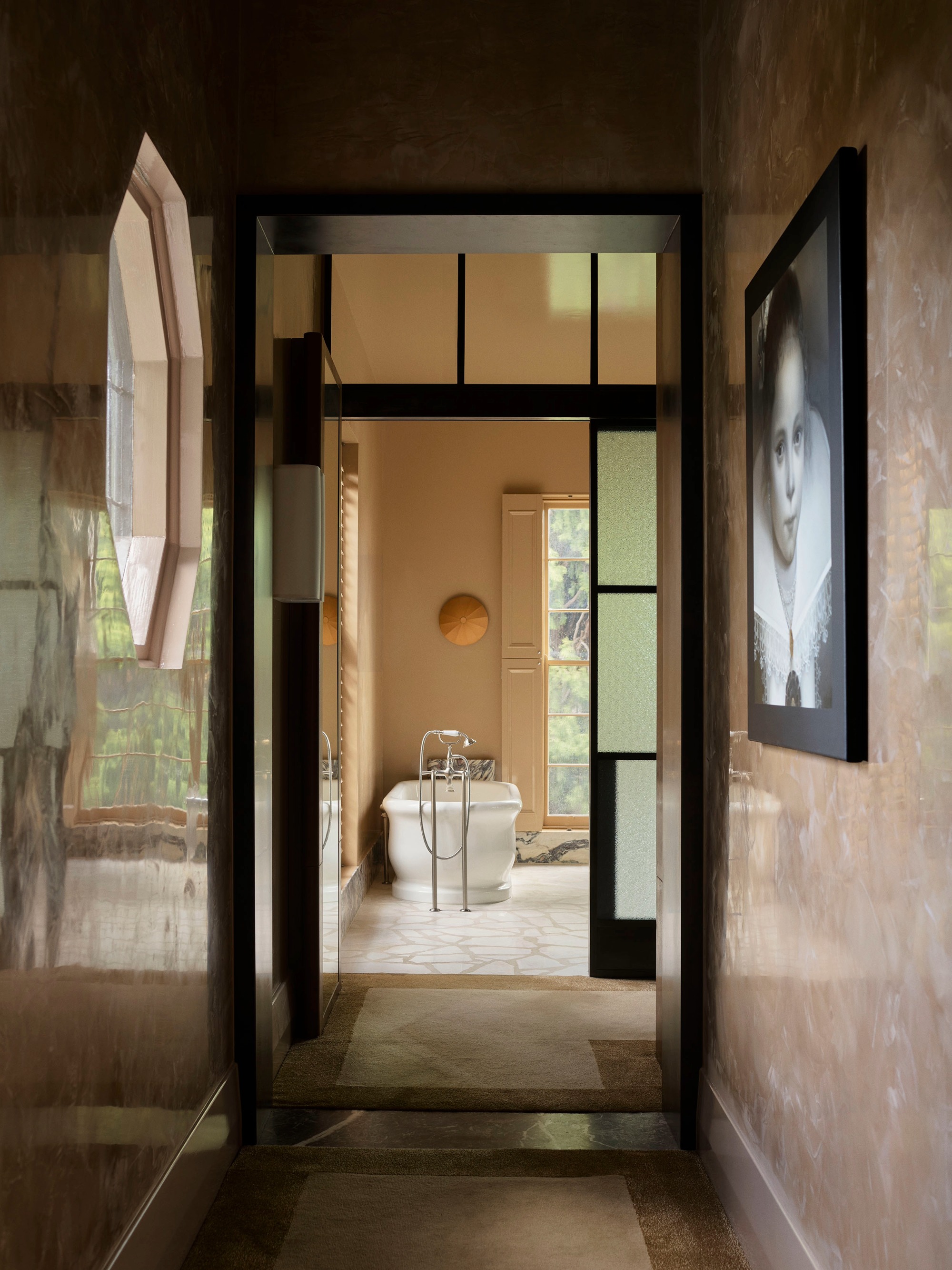 a mustard toned bathroom with a freestanding bath and crazy pave tiles