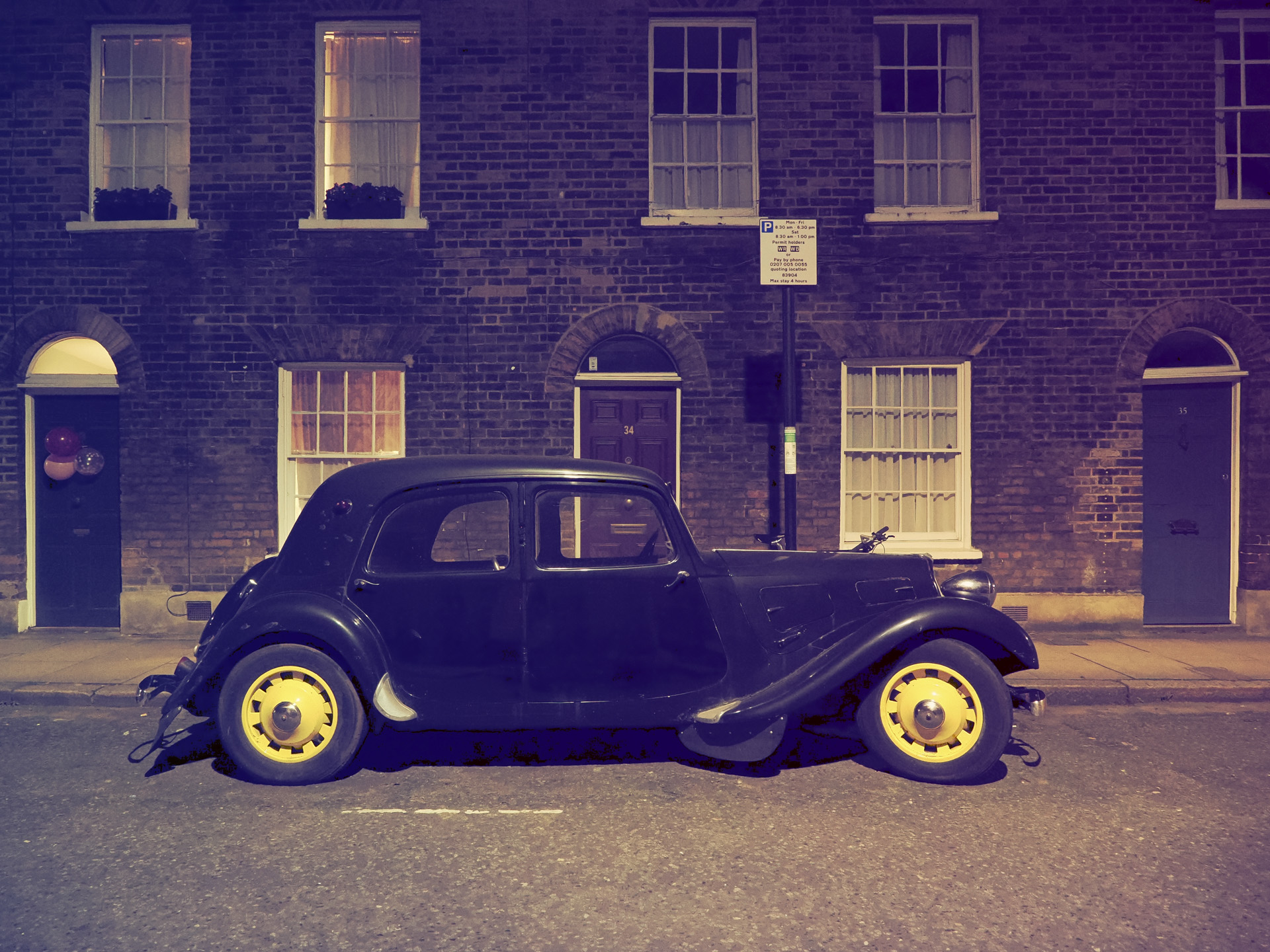 OM System OM-3 sample photos: classic car in quaint London street at night