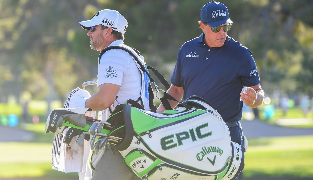 Mickelson looks at his bag