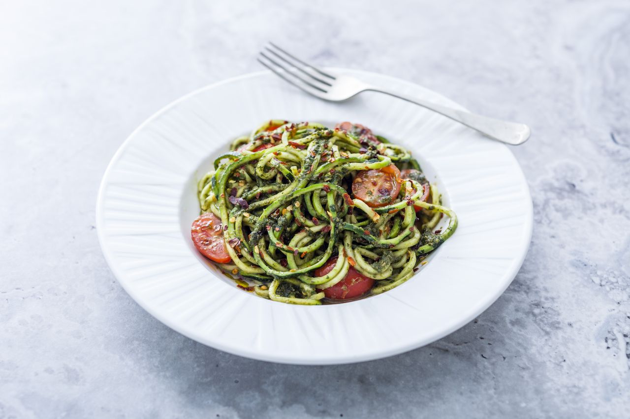 Vegan basil pesto courgetti with tomatoes and chilli