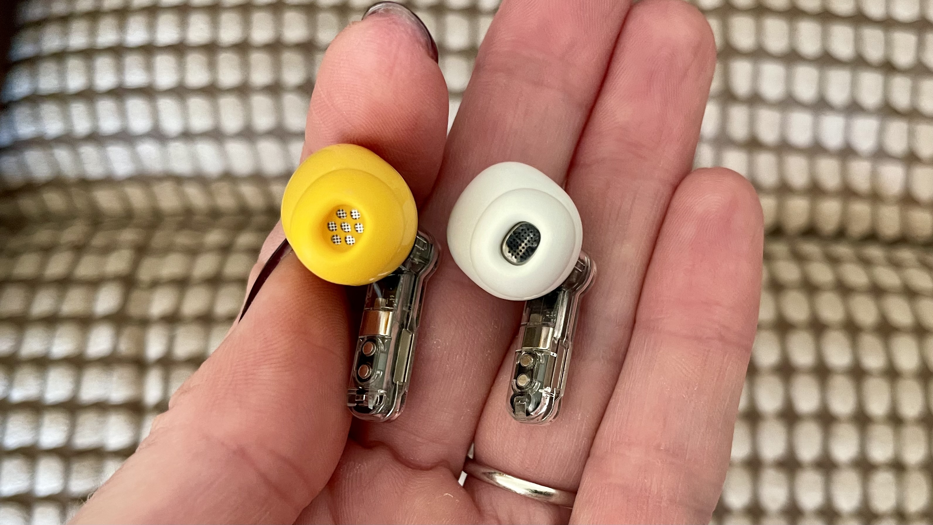 Nothing Ear (a) next to the Nothing Ear (2) earbuds