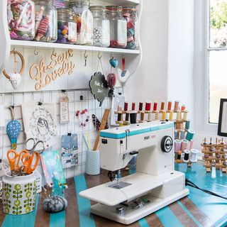 sewing room with white wall and stitch machine