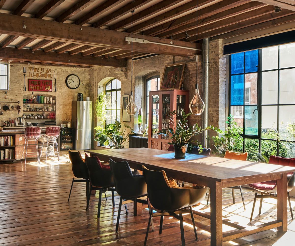 A kitchen-diner with a large wooden table and stained glass windows