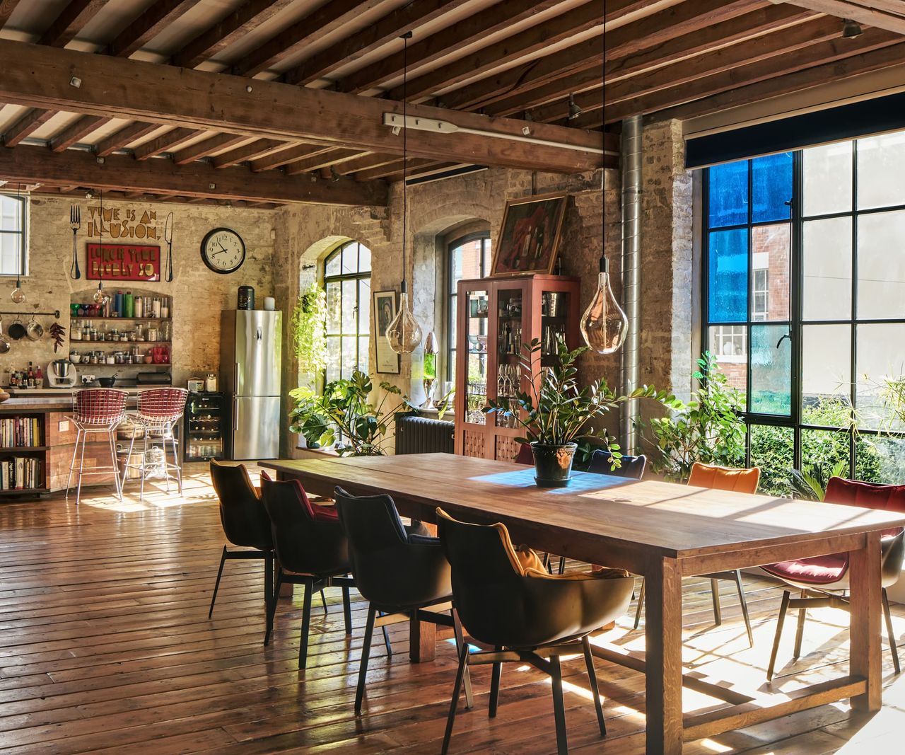 A kitchen-diner with a large wooden table and stained glass windows