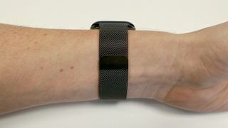 The underside of the Slate Milanese Loop band on someone's wrist showing its clasp