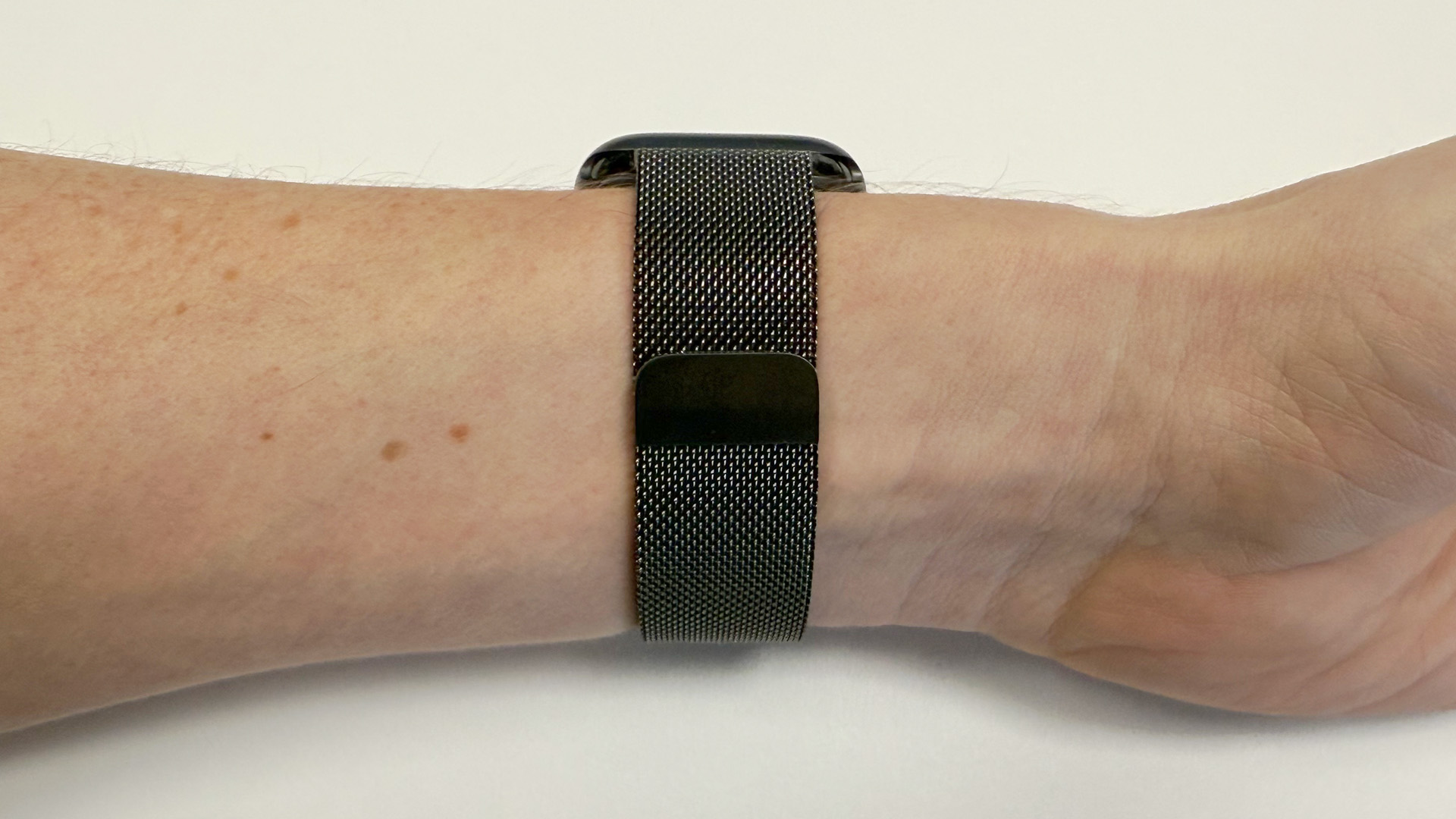 The underside of the Slate Milanese Loop Band on the wrist of a person shows its closure