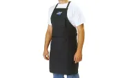 A man in a white t-shirt and blue jeans wearing the black Park Tool Heavy Duty Shop Apron