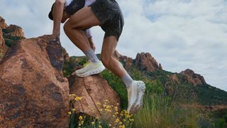 Press shot from On of a runner on a technical trail wearing the On Cloudultra Pro shoes