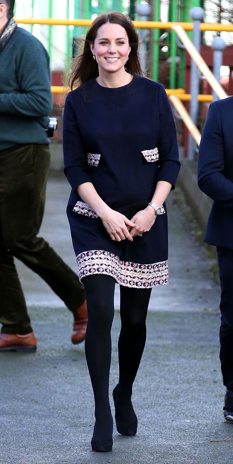 While paying Barlby Primary School a visit, she wears a navy Madderson London shift dress with tweed pattern detail on the pockets and hem.