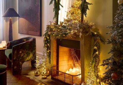 a fireplace decorated for Christmas with garlands and lights