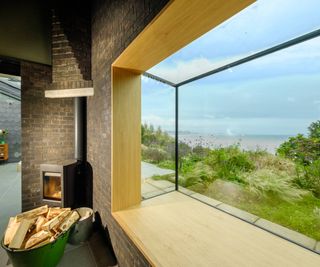 modern style window with deep frame and woodburning stove