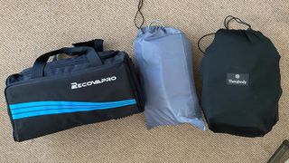 Recovery compression boots in carry bags, from left: Recovapro, Renpho and Therabody