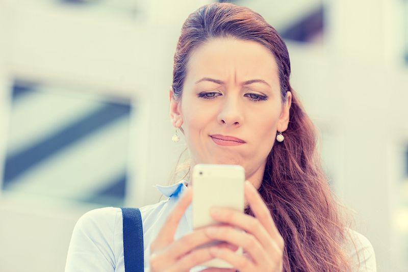 A woman looks at her phone.