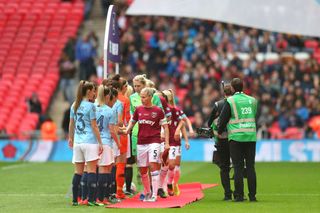 Gilly Flaherty of West Ham United Ladies leads her team as they shake hands with the Manchester City Women's team prior to the Women's FA Cup Final match between Manchester City Women and West Ham United Ladies at Wembley Stadium on May 04, 2019 in London, England.