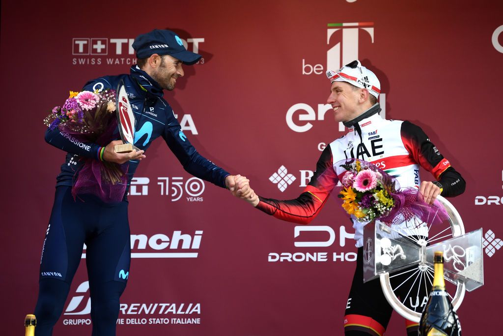 SIENA ITALY MARCH 05 LR Alejandro Valverde Belmonte of Spain and Movistar Team on second place and race winner Tadej Pogacar of Slovenia and UAE Team Emirates pose on the podium ceremony after the Eroica 16th Strade Bianche 2022 Mens Elite a 184km one day race from Siena to Siena Piazza del Campo 321m StradeBianche WorldTour on March 05 2022 in Siena Italy Photo by Tim de WaeleGetty Images