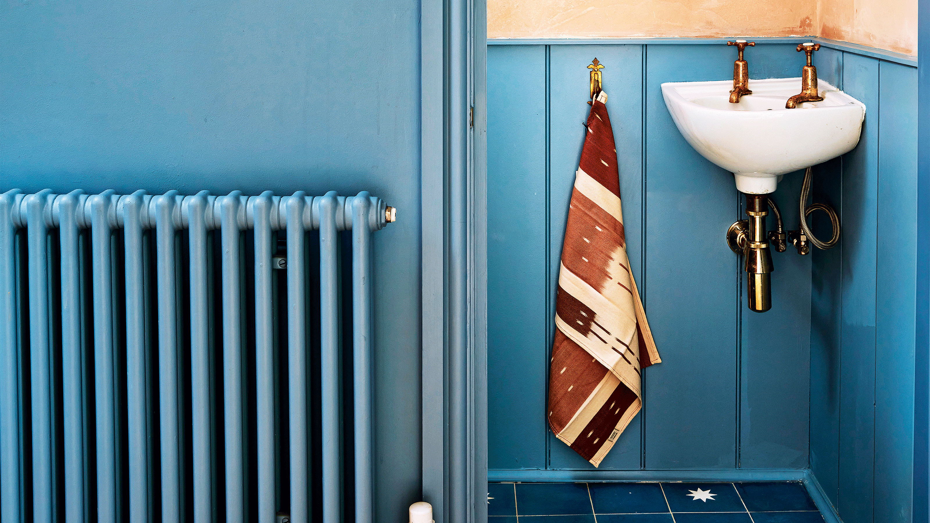 Living room with radiator covered in wooden cover.