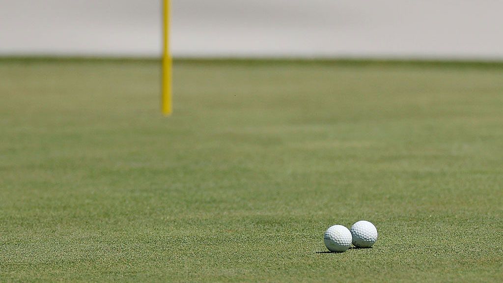 Two golf balls collide