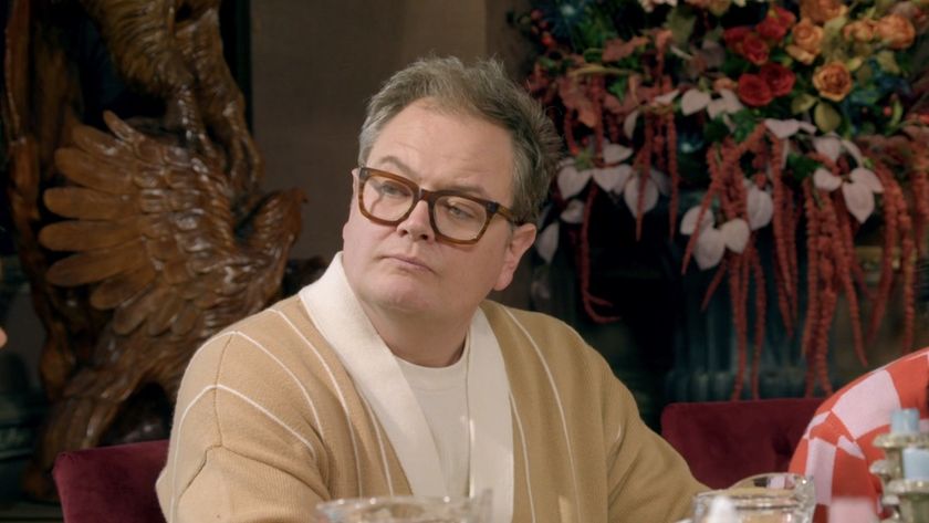 Alan Carr looking pensive at the breakfast table.