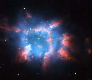 This Hubble Space Telescope photo of a cosmic holiday ornament shows NGC 6326, a planetary nebula of glowing gas surrounding a star that is near the end of its life.