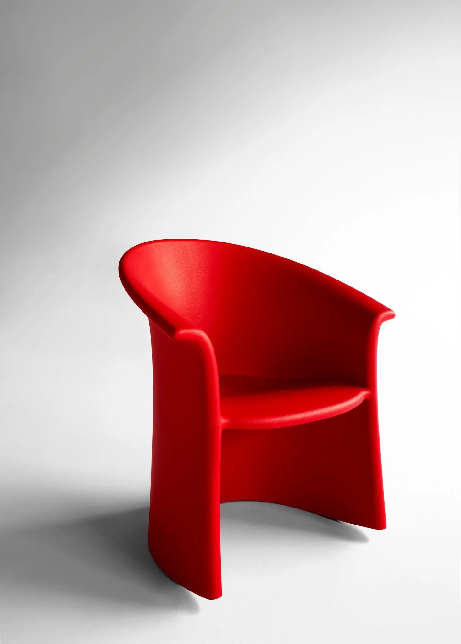 red plastic rocking armchair on white background