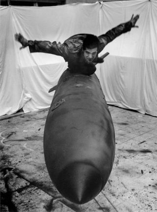 Pino Pascali on a torpedo-like sculpture