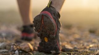 Person walking on pebbles wearing hiking shoes