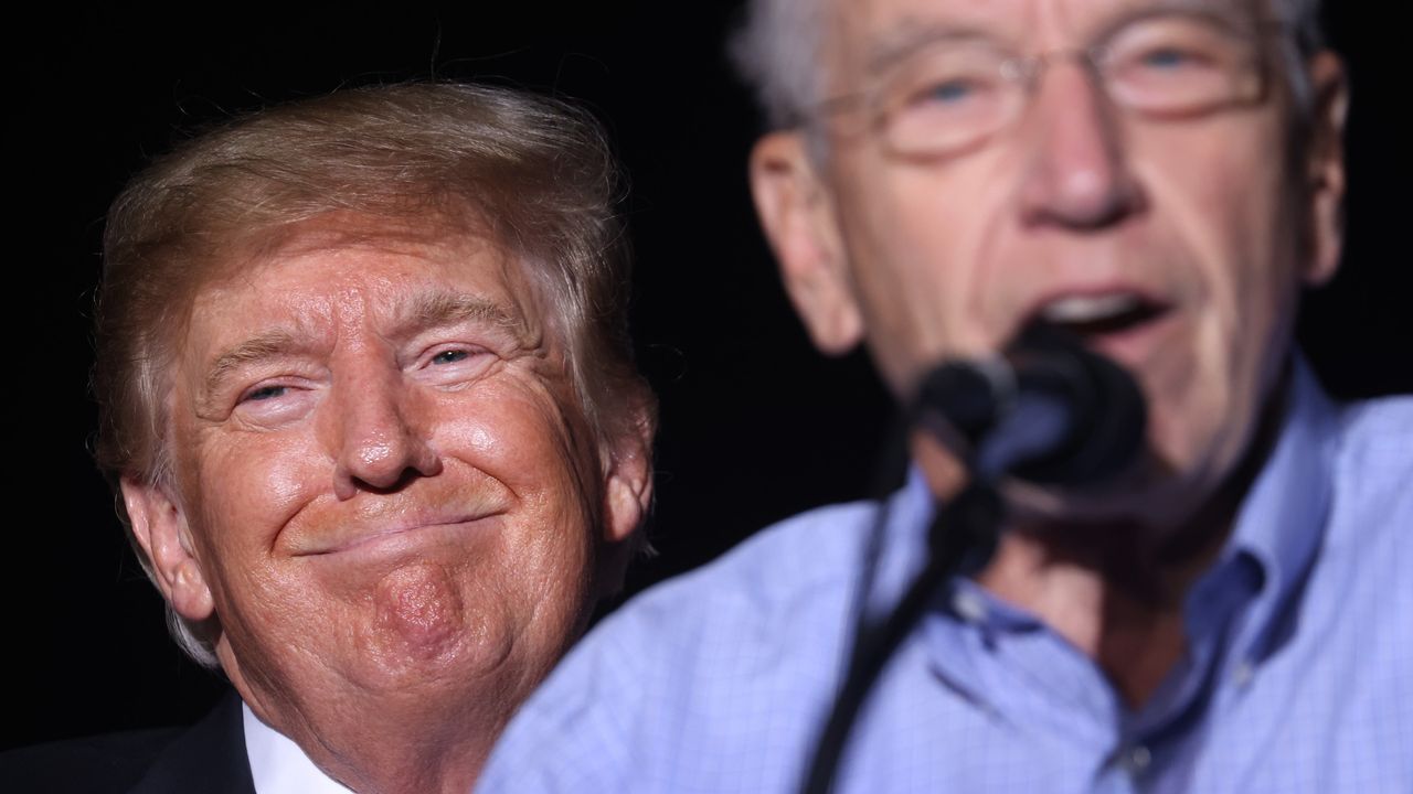 Donald Trump stand behind Republican Senator Chuck Grassley at a rally in Iowa