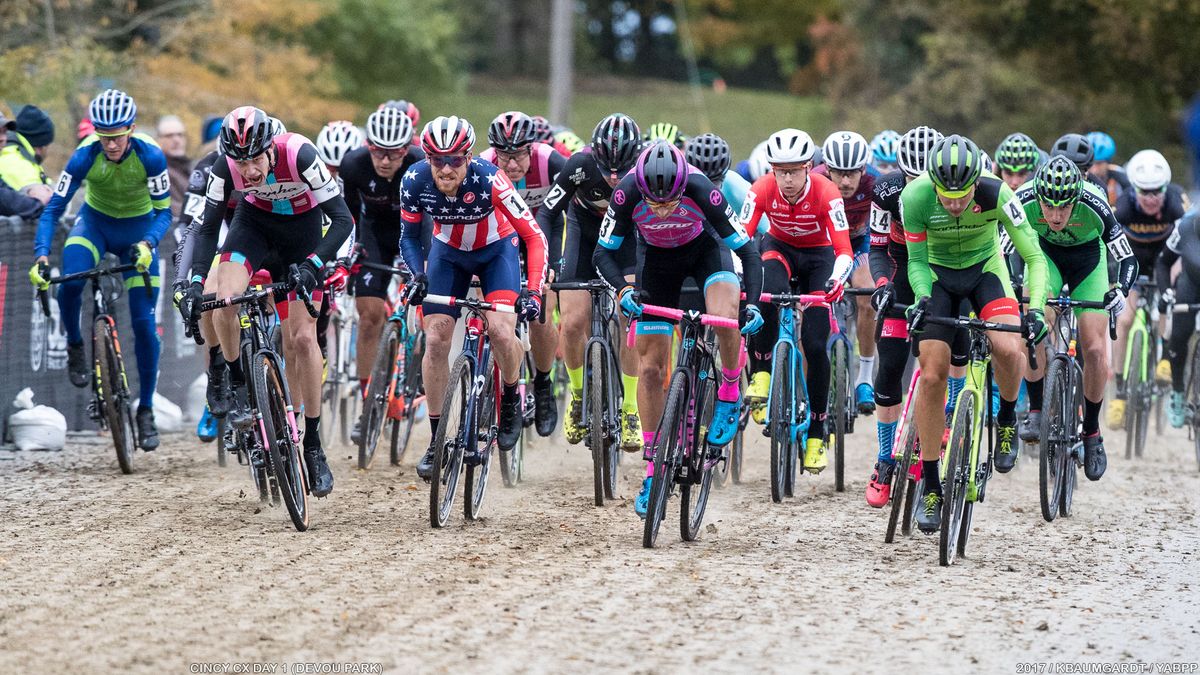 UCI Men charge across the mud-strewn pavement left by a day of racing.