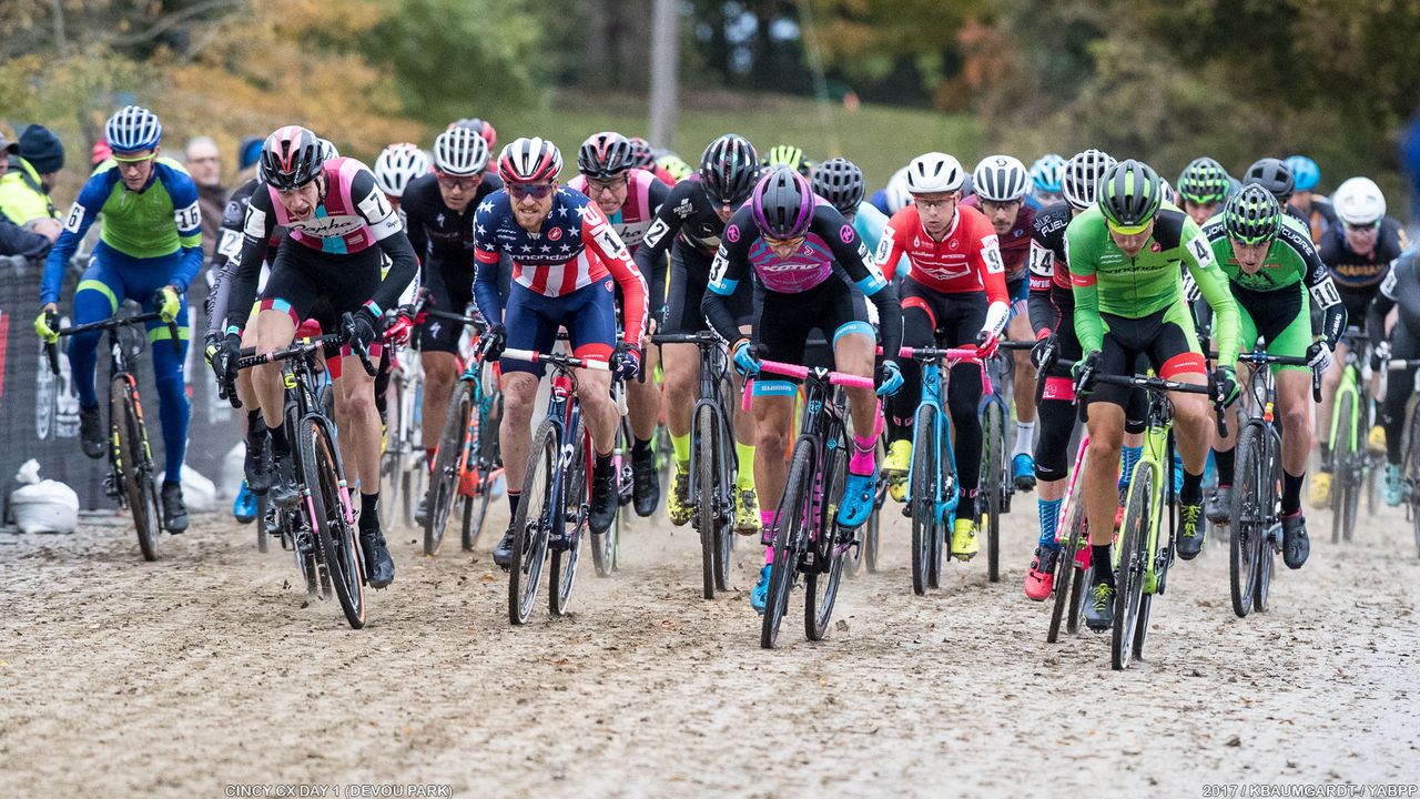 UCI Men charge across the mud-strewn pavement left by a day of racing.