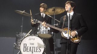 Ringo Starr (playing Ludwig drum kit, drums) and Paul McCartney (playing a Hofner 500/1 violin bass guitar) of English rock and pop group The Beatles perform together on stage for the American Broadcasting Company (ABC) music television show 'Shindig!' at Granville Studios in Fulham, London on 3rd October 1964. The band would play three songs on the show, Kansas City/hey-Hey-Hey!, I'm a Loser and Boys.