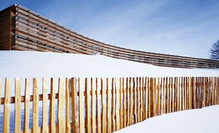 Snowed in building with wooden fence