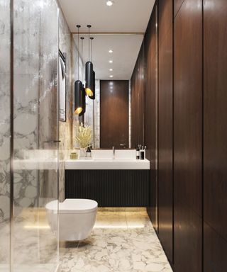 modern bathroom with walnut fitted cupboards and marble floor and walls