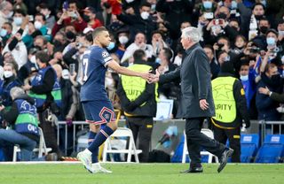 Kylian Mbappe of PSG salutes coach of Real Madrid Carlo Ancelotti following the UEFA Champions League Round Of Sixteen Leg Two match between Real Madrid and Paris Saint-Germain (PSG) at Estadio Santiago Bernabeu on March 9, 2022 in Madrid, Spain. (Photo by John Berry/Getty Images)