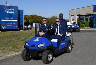 Justin Rose and Luke Donald drive in a golf buggy