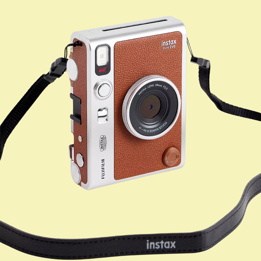 Fujifilm Instax Brown Mini Evo Camera in brown sits against pale yellow background.